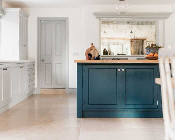 Beautifully design kitchen with blue cabinets on a freestanding kitchen island