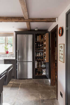 pantry opening with fridge freezer